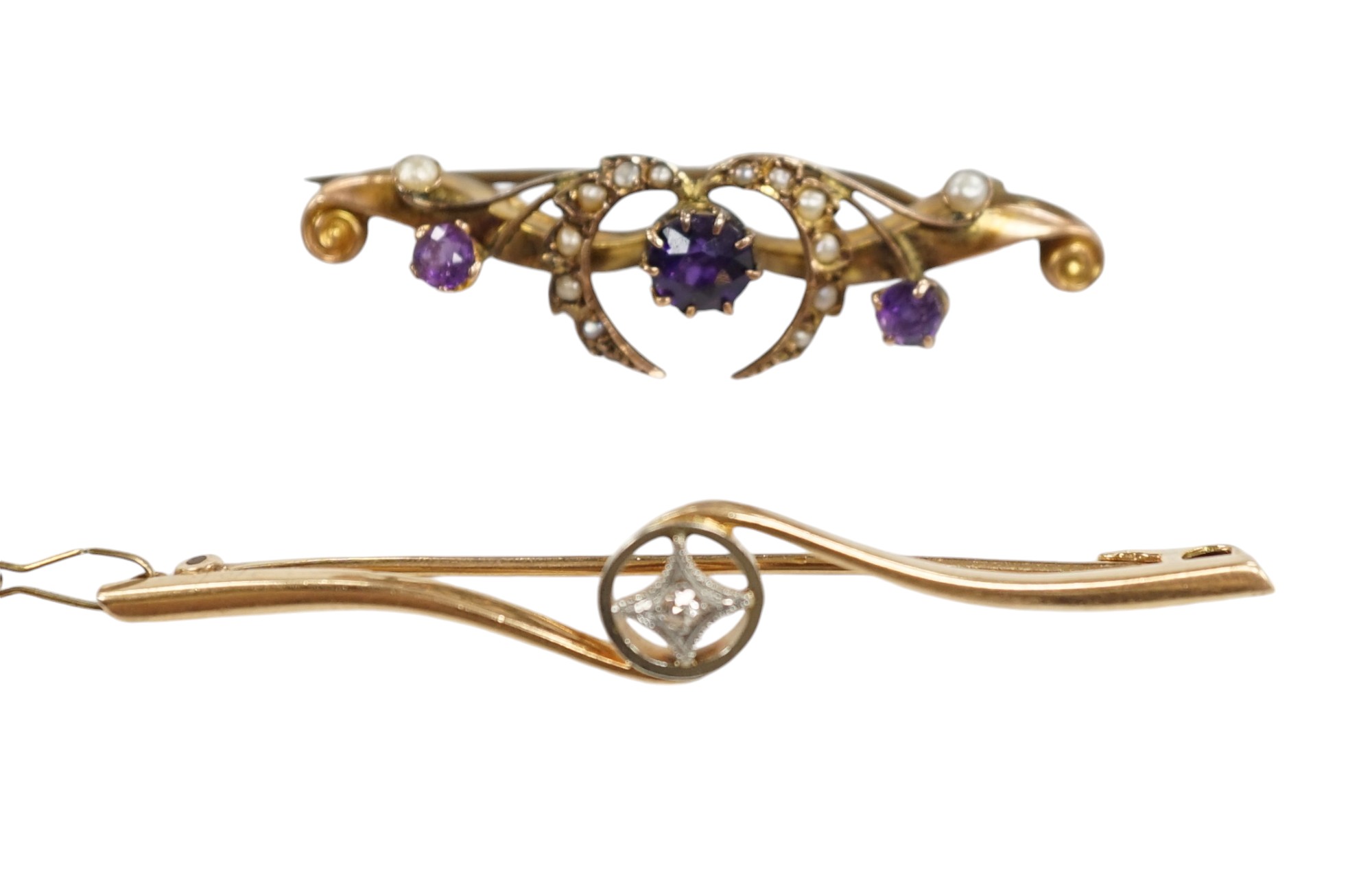 An Edwardian 15ct and diamond set crossover bar brooch, 57mm, gross weight 3.9 grams, together with a similar 9ct gold, amethyst and seed pearl set bar brooch, gross weight 2.3 grams. Condition - fair